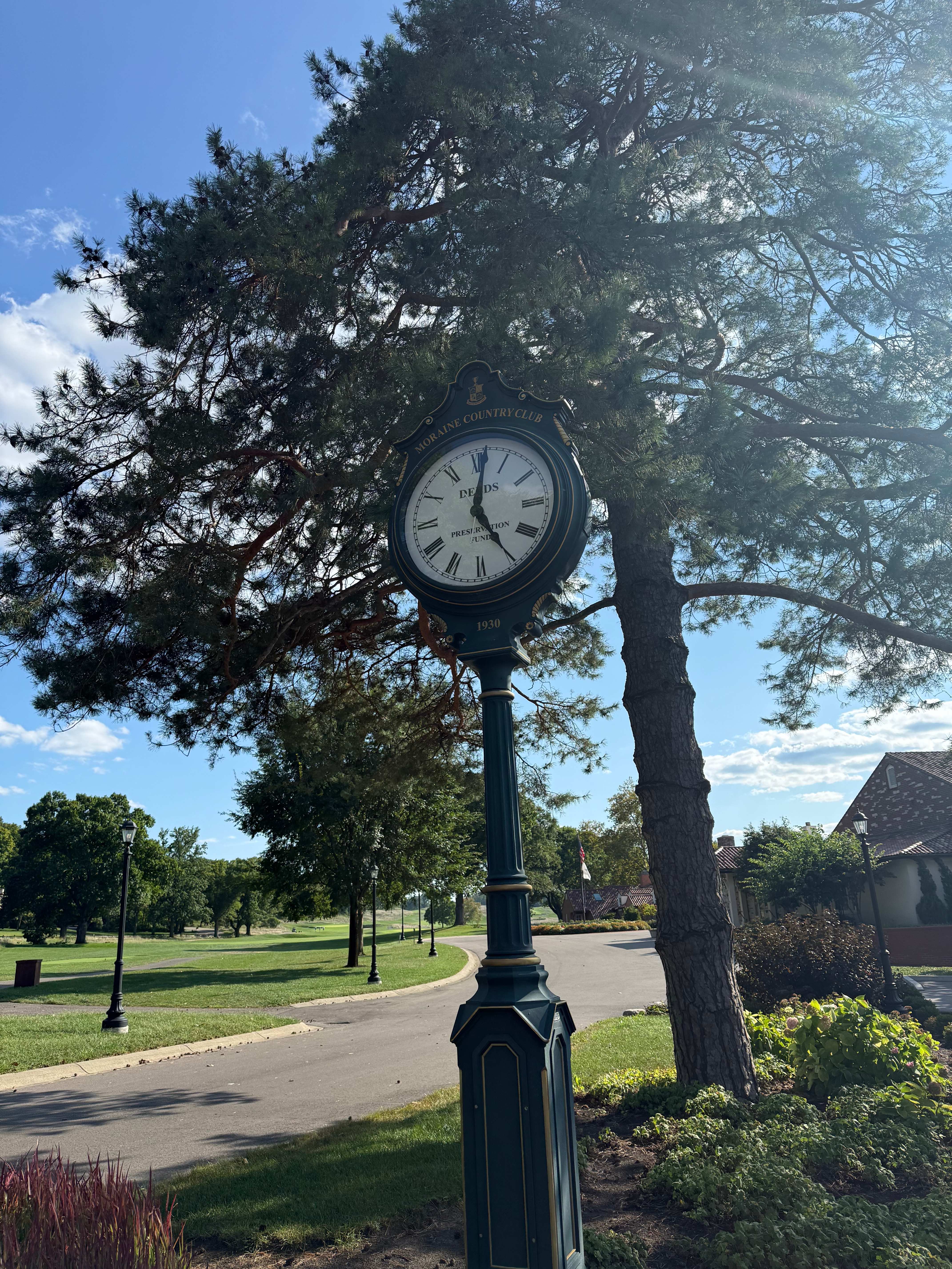 The 1930 Moraine Country Club clock beneath a pine tree